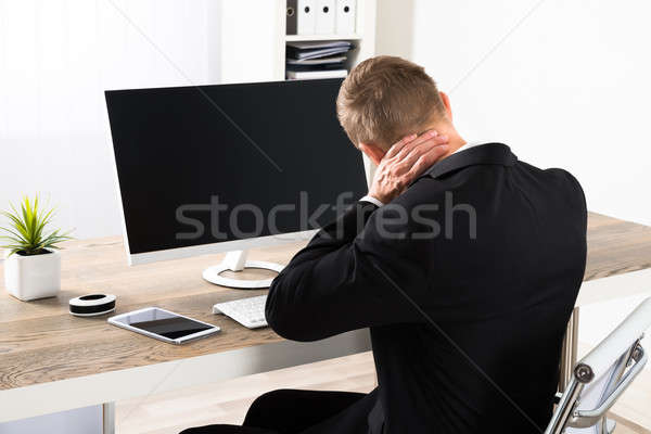 Businessman Suffering From Neck Ache Stock photo © AndreyPopov