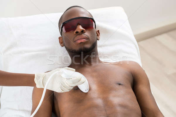 Therapist Giving Laser Epilation On Man's Chest Stock photo © AndreyPopov
