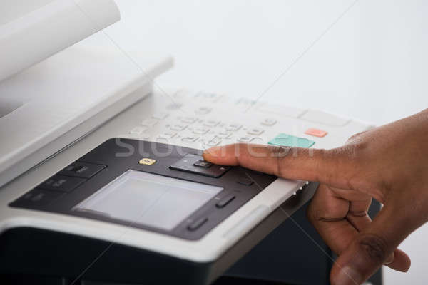 Businesswoman Pressing Printer's Button Stock photo © AndreyPopov