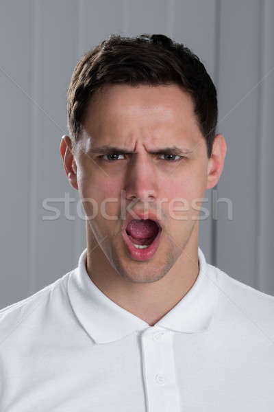 Retrato homem gritando foto zangado moço Foto stock © AndreyPopov