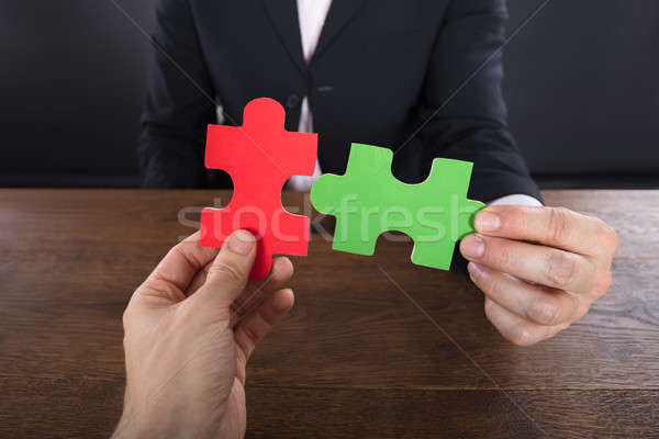 Two Businessmen Joining Jigsaw Pieces Stock photo © AndreyPopov