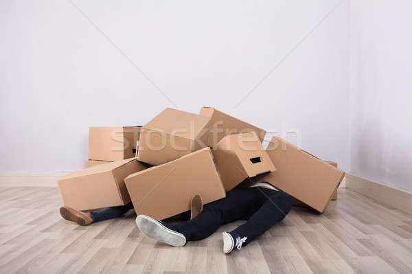 Couple Lying Under The Cardboard Boxes Stock photo © AndreyPopov