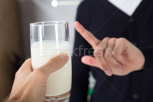 Person Rejecting Glass Of Milk Stock photo © AndreyPopov