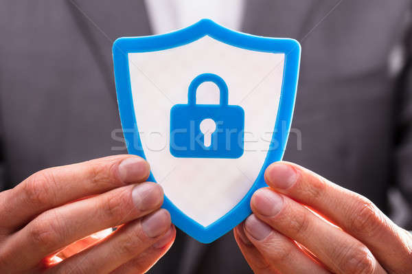 Businessperson Holding Shield Security Icon Stock photo © AndreyPopov