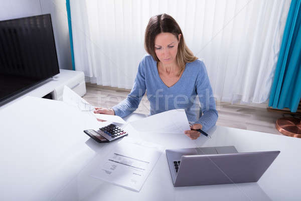 Woman Calculating Invoice With Calculator At Home Stock photo © AndreyPopov