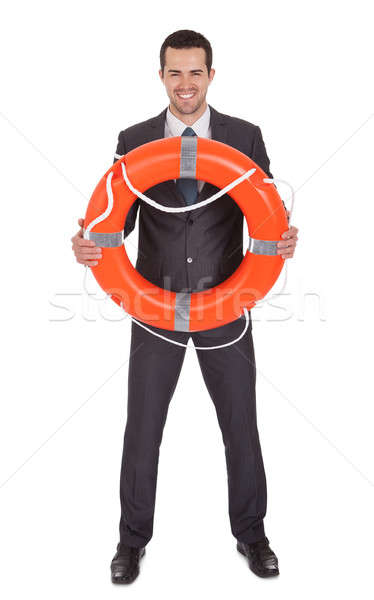 Young businessman with life buoy Stock photo © AndreyPopov