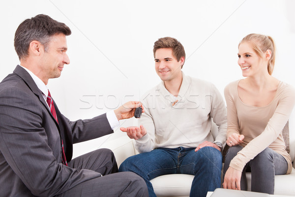 Stock photo: Salesman Giving Car Key To Couple