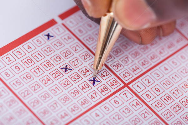 Person Marking Number On Lottery Ticket Stock photo © AndreyPopov