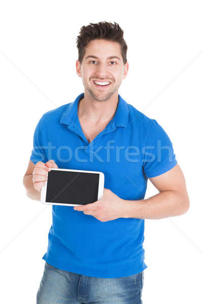 Handsome Man Displaying Digital Tablet Stock photo © AndreyPopov