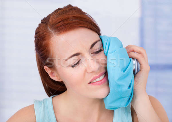 Woman Touching Cheek With Hot Water Bag Stock photo © AndreyPopov
