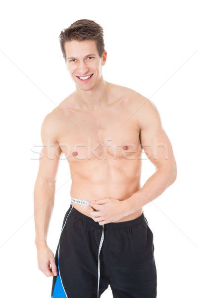 Young Man Measuring His Waist Stock photo © AndreyPopov