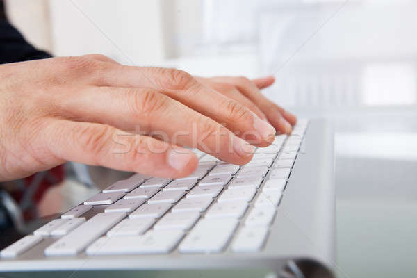 Businessman Typing On Keyboard At Desk Stock photo © AndreyPopov