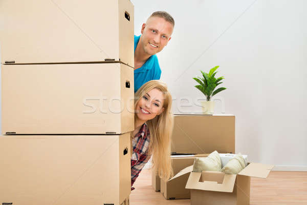 Couple Peering From Behind Boxes Stock photo © AndreyPopov