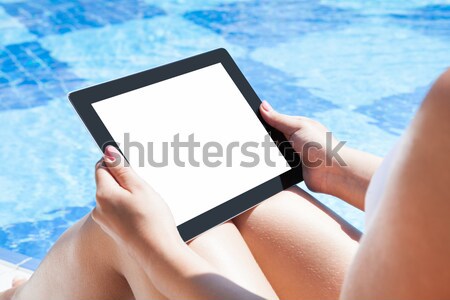 Stock photo: Woman Holding Digital Tablet At Poolside
