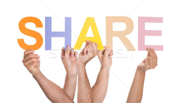 Stock photo: Group Of People Holding The Word Share