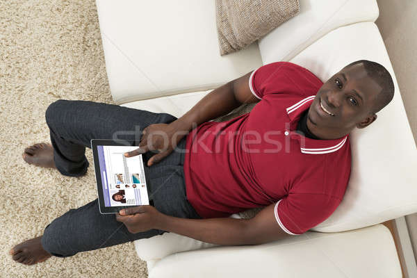 Man Surfing On Social Networking Website Stock photo © AndreyPopov