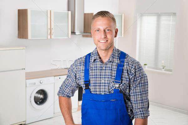 Stock photo: Repairman In The Kitchen