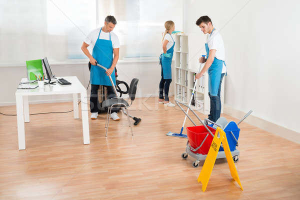 Janitors In Blue Apron Cleaning Office Stock photo © AndreyPopov
