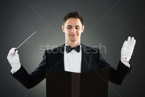 Smiling Music Conductor Holding Baton Stock photo © AndreyPopov