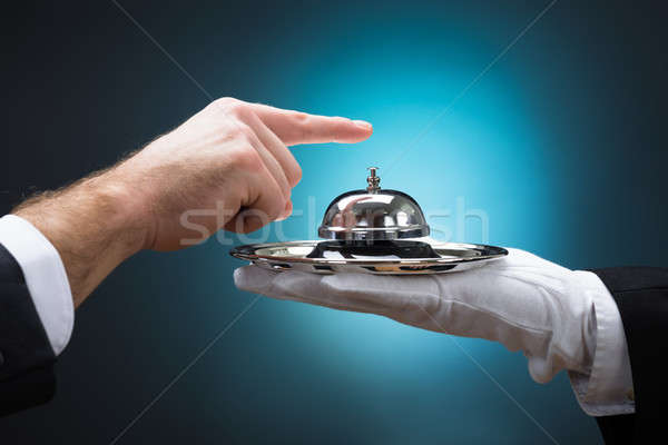 Businessman Ringing In Service Bell Held By Bellboy Stock photo © AndreyPopov
