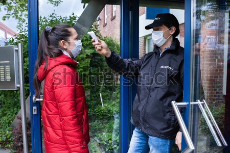 Hooded Man Using Crowbar To Open Glass Door Stock photo © AndreyPopov