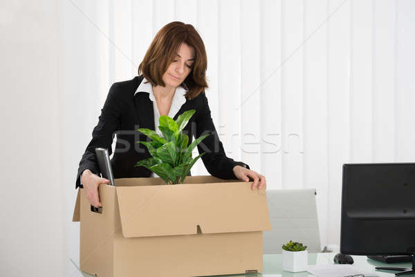 Sad Businesswoman Packing Her Belongings In Box Stock photo © AndreyPopov