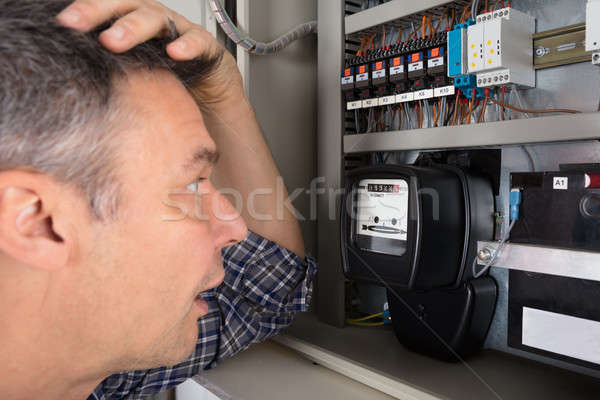 Shocked Man Looking At Meter Stock photo © AndreyPopov