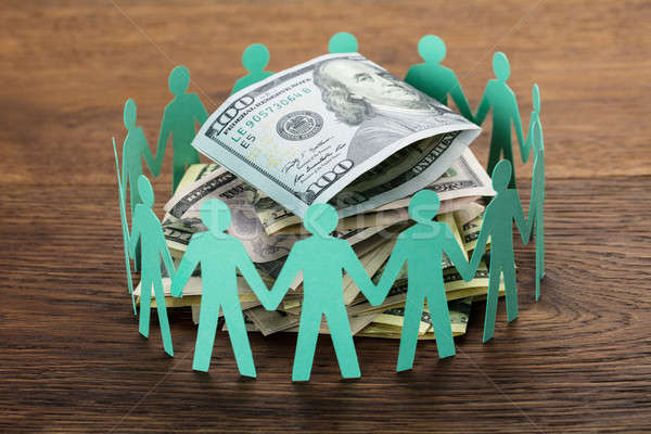 Cut-out Figures Around The Hundred Dollar Bill Stock photo © AndreyPopov