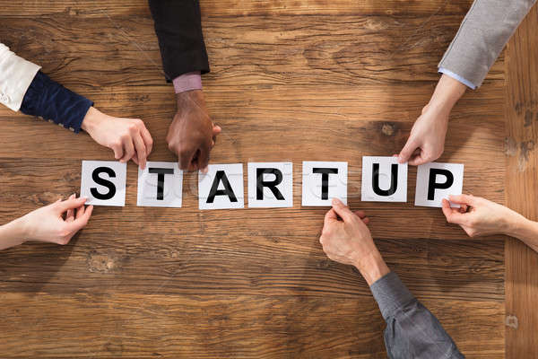 Businesspeople Hands Arranging Start Up Word Stock photo © AndreyPopov