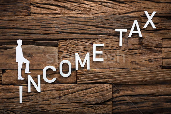 Paper Businessman Climbing Income Ladder On Wood Stock photo © AndreyPopov