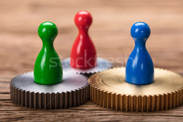 Closeup Of Colorful Pawn Figurines On Cogwheels Stock photo © AndreyPopov