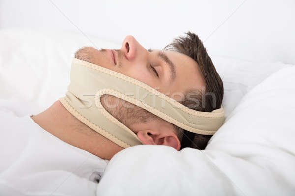 Man Sleeping With Anti Snoring Bandage Stock photo © AndreyPopov
