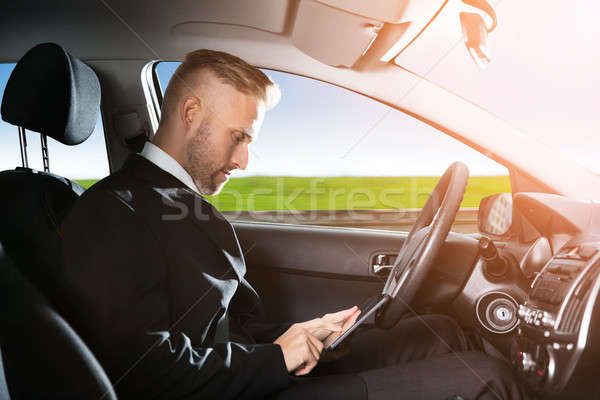 Businessman Sitting Inside Self Driving Car Stock photo © AndreyPopov