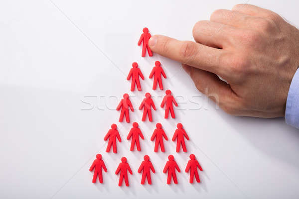 Red Human Figures Arranged In Triangular Shape Stock photo © AndreyPopov
