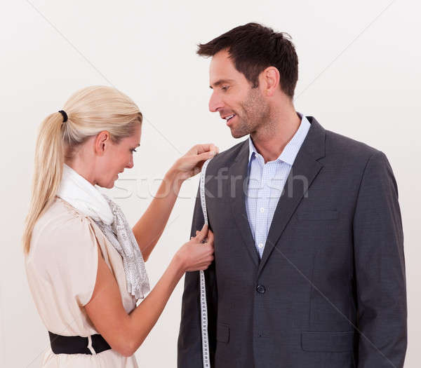 Seamstress measuring a man for a suit Stock photo © AndreyPopov