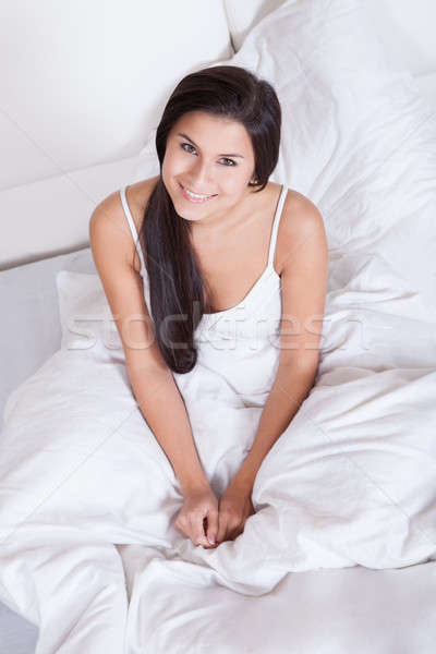 Pretty woman snuggling down in bed Stock photo © AndreyPopov