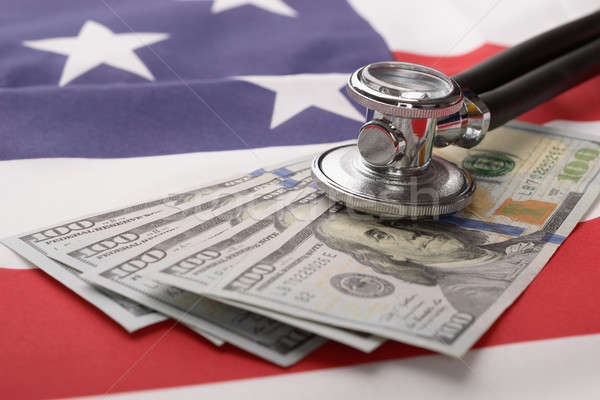 Stethoscope On Us Currency And American Flag Stock photo © AndreyPopov