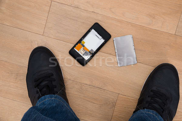 Person Standing Near Broken Cellphone Stock photo © AndreyPopov