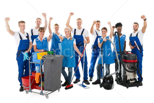 Happy Janitors With Arms Raised Holding Cleaning Equipment Stock photo © AndreyPopov