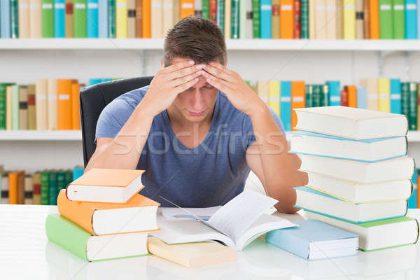 Tensed University Student Sitting In Library Stock photo © AndreyPopov