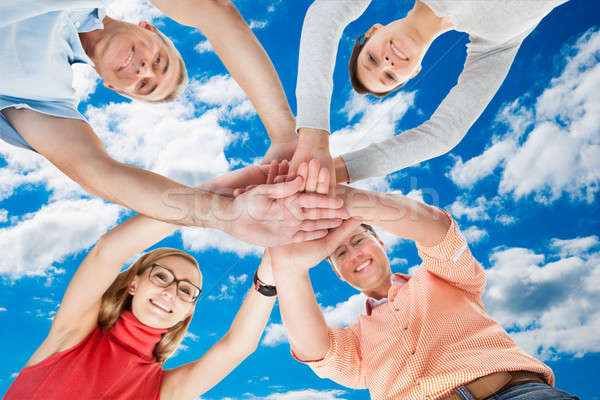 Happy Friends Stacking Hands Against Sky Stock photo © AndreyPopov
