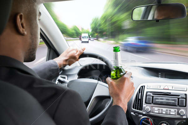 Businessman Holding Beer While Driving Car Stock photo © AndreyPopov