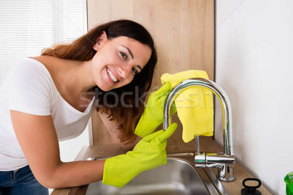 Happy Woman Cleaning The Tap Stock photo © AndreyPopov