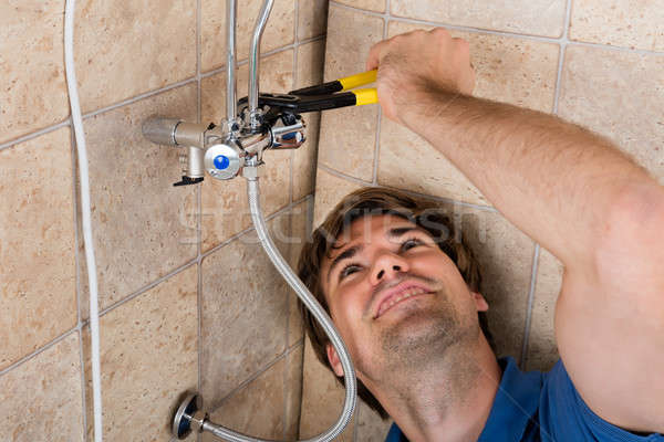 Plumber Repairing Electric Boiler With Wrench Stock photo © AndreyPopov