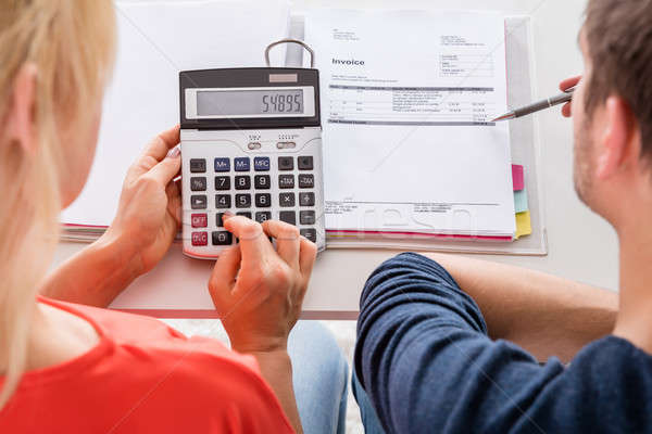 Couple Using Calculator For Calculating Invoice Stock photo © AndreyPopov