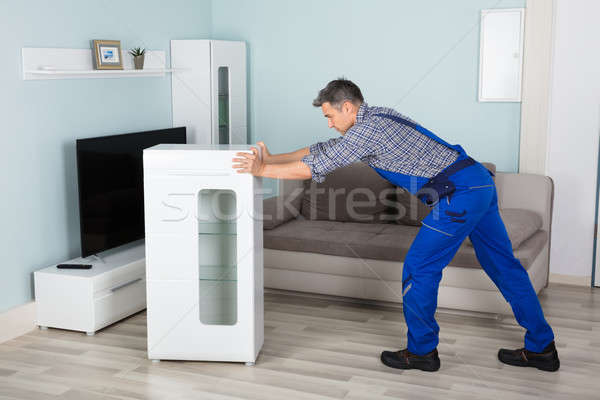 Mover Placing Furniture At Home Stock photo © AndreyPopov