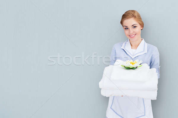 Young Maid Holding Towels Stock photo © AndreyPopov