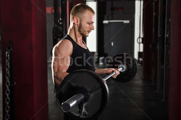 Homem barbell moço corpo perfeito ginásio Foto stock © AndreyPopov