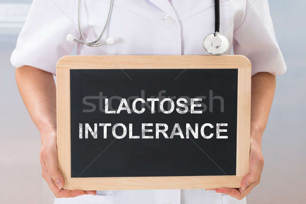 Doctor With The Text Lactose Intolerance On Chalkboard Stock photo © AndreyPopov