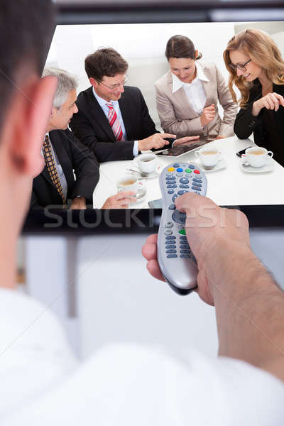 Man changing television channel through remote Stock photo © AndreyPopov